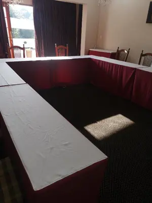 a long table with a red and white table cloth at Erasmus manor Guest House in Pretoria