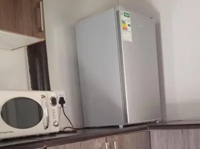 a microwave sitting on top of a kitchen counter at Kaste guesthouse Tzaneen in Tzaneen