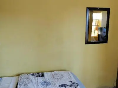 a bedroom with a bed with a mirror on the wall at Kaste guesthouse Tzaneen in Tzaneen