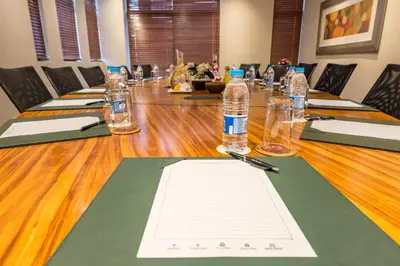 a long wooden table with bottles of water on it at City Lodge Hotel Hatfield, Pretoria in Pretoria