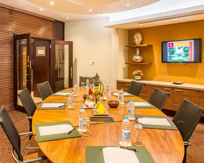 a conference room with a large wooden table and chairs at City Lodge Hotel Hatfield, Pretoria in Pretoria
