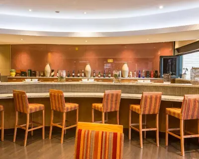 a bar in a restaurant with chairs around it at City Lodge Hotel Hatfield, Pretoria in Pretoria