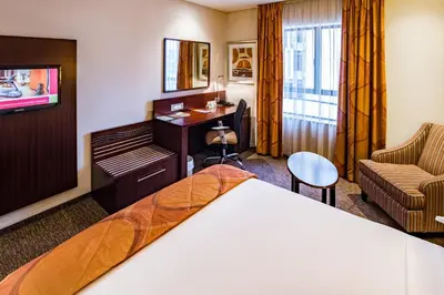 a hotel room with a bed and a desk at City Lodge Hotel Hatfield, Pretoria in Pretoria