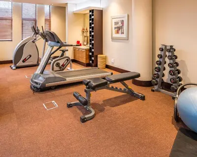 a gym with two exercise bikes and a treadmill at City Lodge Hotel Hatfield, Pretoria in Pretoria
