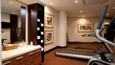 a bathroom with a gym with a treadmill and a treadmill at City Lodge Hotel Hatfield, Pretoria in Pretoria