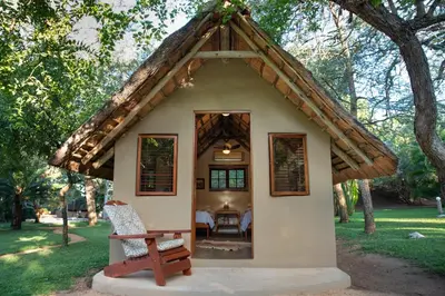 a small house with a thatched roof at Shumba Safari Bush Camp in Hoedspruit