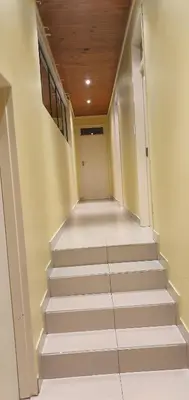 an empty hallway with stairs in a house at TERTIUS LODGE in Nelspruit
