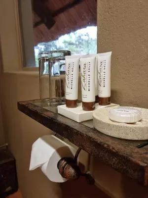 a counter with four bottles of soap on it at Bass Lake Country Lodge in Pretoria