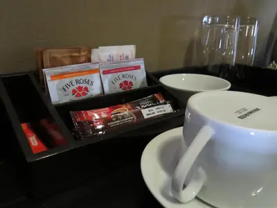 a cup of coffee sitting on a table with books at Bass Lake Country Lodge in Pretoria