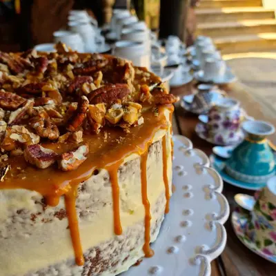 a cake with walnuts on top of it on a table at Bass Lake Country Lodge in Pretoria