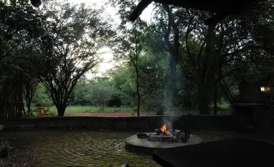 a fire pit in the middle of a yard at Kiburi Cottage @ Kruger in Marloth Park