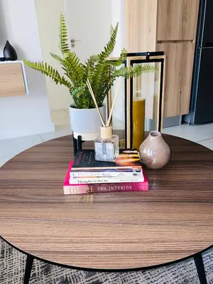 a table with books and a potted plant on it at The Blyde - Unit 1136 in Pretoria