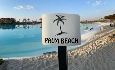 a sign on a beach with a palm tree on it at The Blyde - Unit 1136 in Pretoria