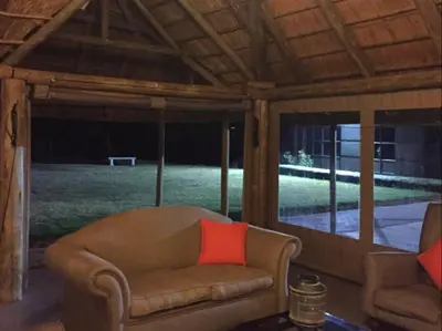 a couch with a red pillow in a living room at Vista ORT in Kempton Park