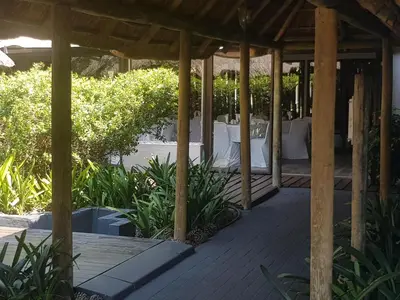 a wooden pavilion with a table in a garden at Vista ORT in Kempton Park