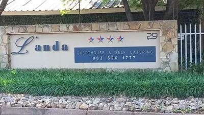 a sign for a business and see office at L'anda Guesthouse & self catering in Middelburg