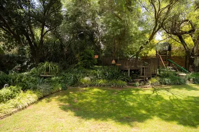 a yard with a garden with trees and grass at L'anda Guesthouse & self catering in Middelburg