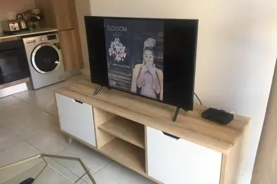 a flat screen tv sitting on top of a table at THE BLYDE CRYSTAL LAGOON BEACH PRETORIA in Pretoria
