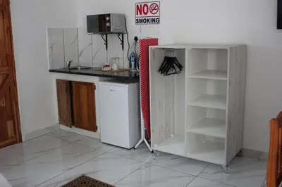 a kitchen with a white refrigerator and a shelf at El Palmar Guesthouse in Groblersdal