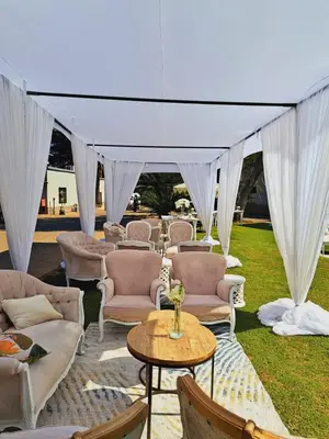 a group of chairs and tables under a tent at Oasis Hotel in Mokopane