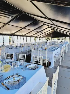a group of tables and chairs in a tent at Oasis Hotel in Mokopane