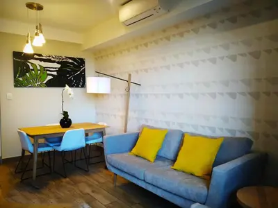 a living room with a blue couch and a table at Regency Apartment in Pretoria