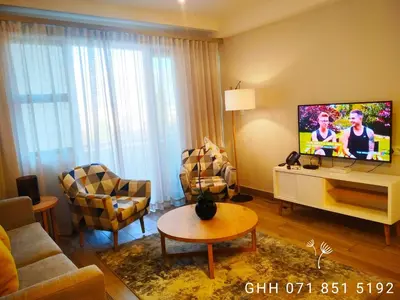 a living room with a couch and a tv in it at Regency Apartment in Pretoria