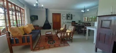 a living room with a couch and a table at Schaefers' Halt in Dullstroom