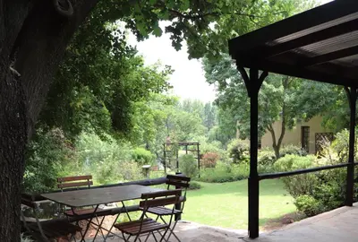 a picnic table and chairs in a garden at Schaefers' Halt in Dullstroom