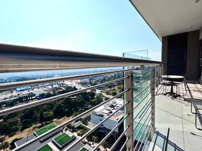a balcony with a view of a city at Menlyn Maine Apartments in Pretoria