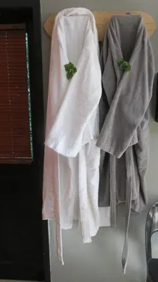 two towels hanging on a shelf in a kitchen at Beni Apartment in Pretoria