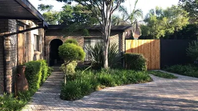 a brick driveway leading to a house at Beni Apartment in Pretoria
