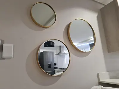 three mirrors on a wall in a bathroom at Villa Casa Lifestyle in Nelspruit