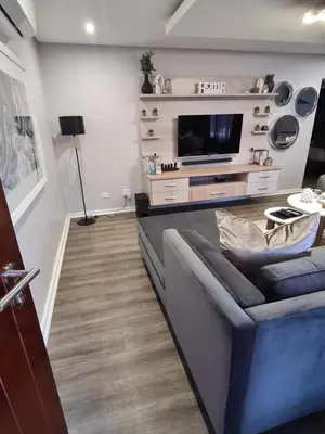 a living room with a couch and a tv at Villa Casa Lifestyle in Nelspruit