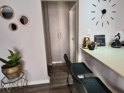 a kitchen with a counter and a clock on the wall at Villa Casa Lifestyle in Nelspruit
