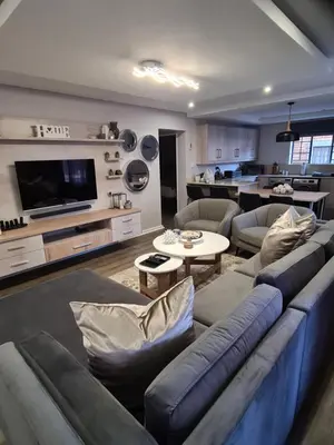 a living room with a blue couch and a table at Villa Casa Lifestyle in Nelspruit