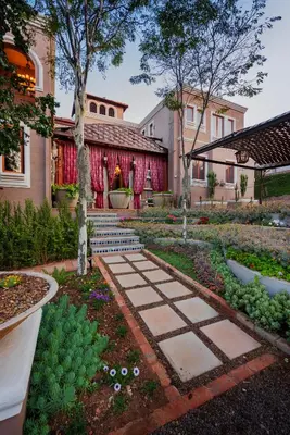 a garden with a stone path in front of a building at 40 on Aspen in Centurion