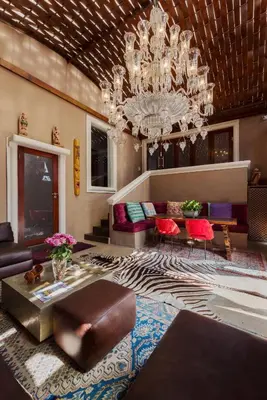 a large living room with a chandelier and a couch at 40 on Aspen in Centurion