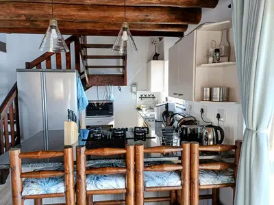 a kitchen with a stove and a refrigerator at Sedgefield Lodge in Witbank