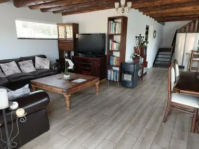 a living room with a couch and a coffee table at Sedgefield Lodge in Witbank