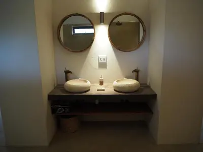 a bathroom with two sinks and a mirror at Pata Pata House in Marloth Park