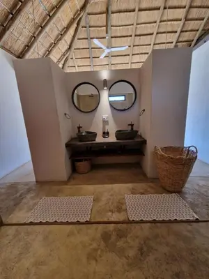 a bathroom with two sinks and two mirrors at Pata Pata House in Marloth Park