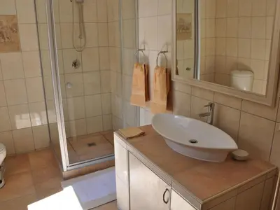 a bathroom with a sink and a shower at Bellstone B&B in Pretoria