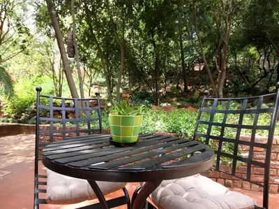a wooden table with a potted plant on a patio at Bellstone B&B in Pretoria