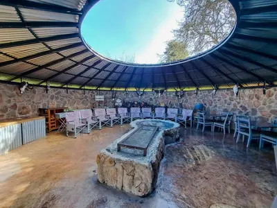 a large room with a table and chairs in it at Dullstroom Manor Game & Trout Lodge in Dullstroom