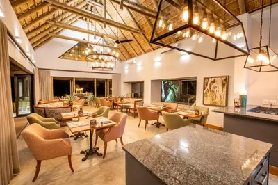 a large dining room with tables and chairs at Simbavati Camp George in Klaserie Private Nature Reserve