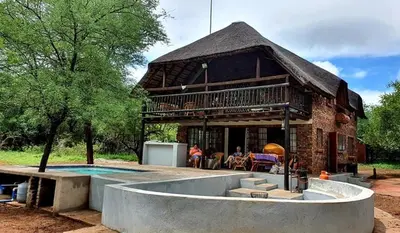 a house with a pool in front of it at Athule Inn Marloth - House in Marloth Park