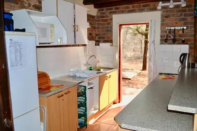 a kitchen with a sink and a refrigerator at Athule Inn Marloth - House in Marloth Park
