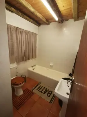 a bathroom with a tub and a toilet and a sink at Athule Inn Marloth - House in Marloth Park