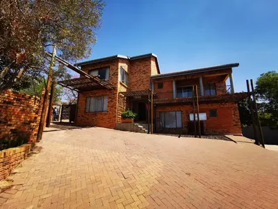 a brick house with a driveway in front of it at 94onWild in Pretoria